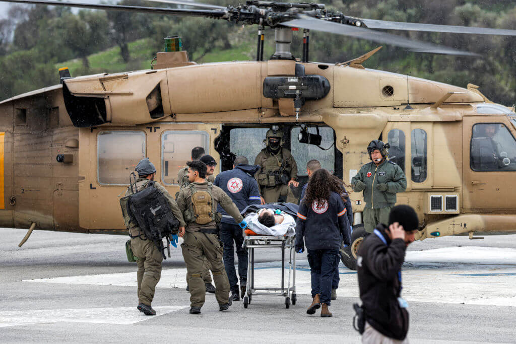 An Israeli medical team transports a person wounded in a rocket attack fired from southern Lebanon in Israel's northern city of Safed on February 14, 2024.