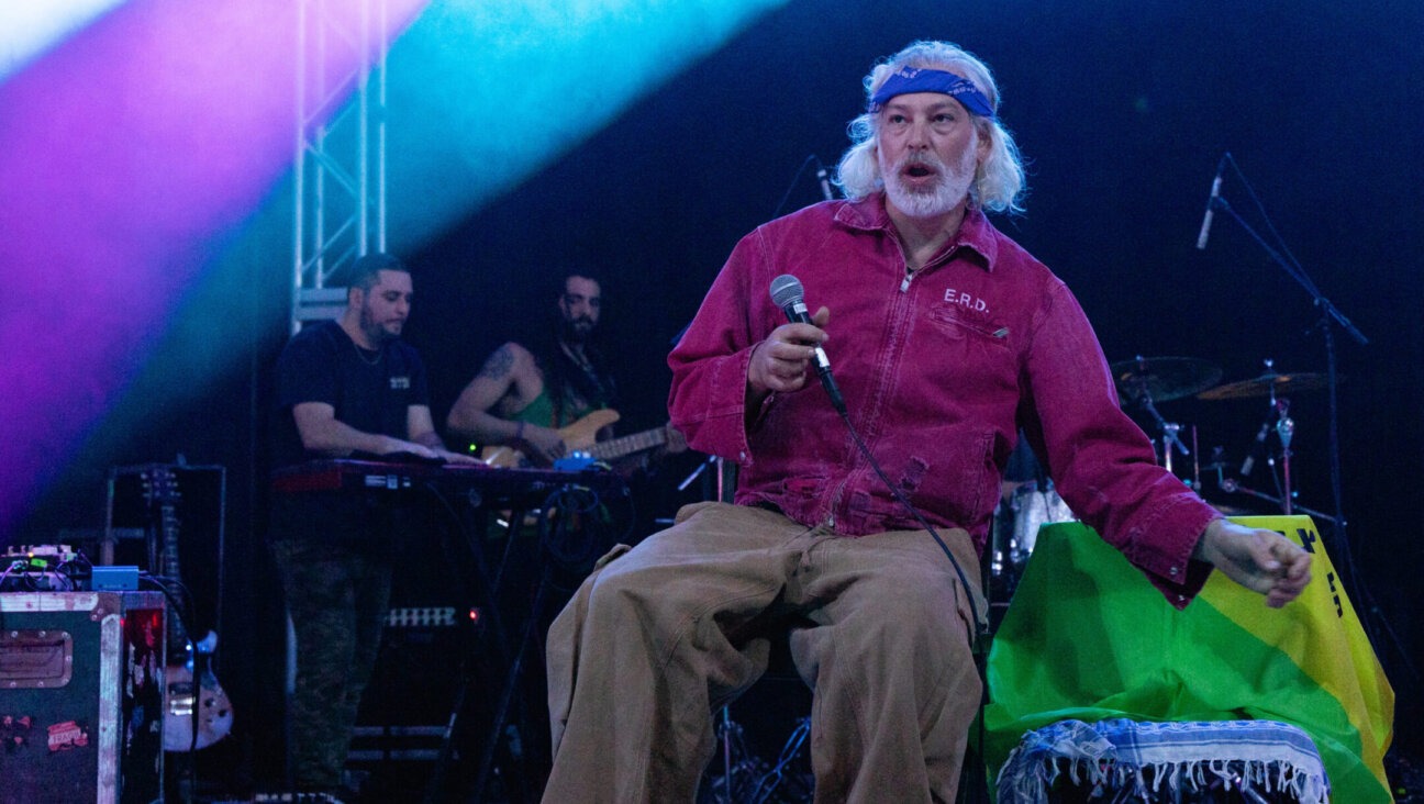 Matisyahu performs in concert during the “Hold The Fire Tour” at Stubb’s Waller Creek Amphitheater in Austin, Texas, Feb. 10, 2024. An Israeli flag and a flag of an Israeli army unit, Golani, are visible on the chair next to him. (Rick Kern/Getty Images)