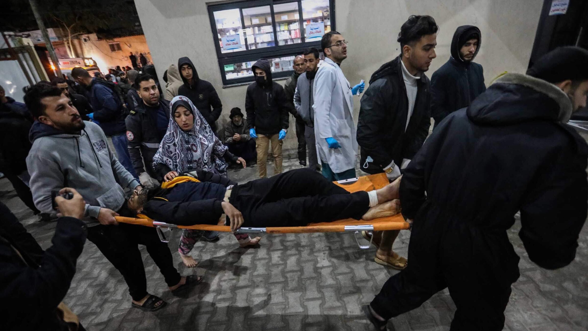 An injured Palestinian is carried to Kuwait Hospital after Israeli air strikes in Gaza on February 12, 2024. 