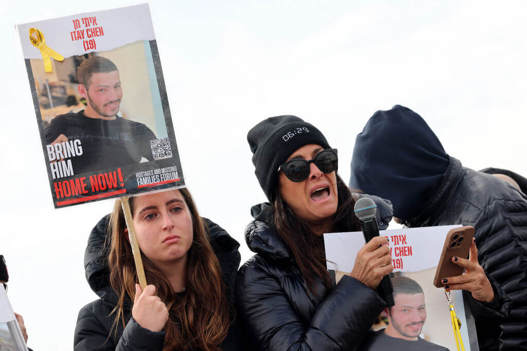 Relatives of Israeli hostages held by the Palestinian Hamas movement carry a picture of Itay Chen in January, 2024.