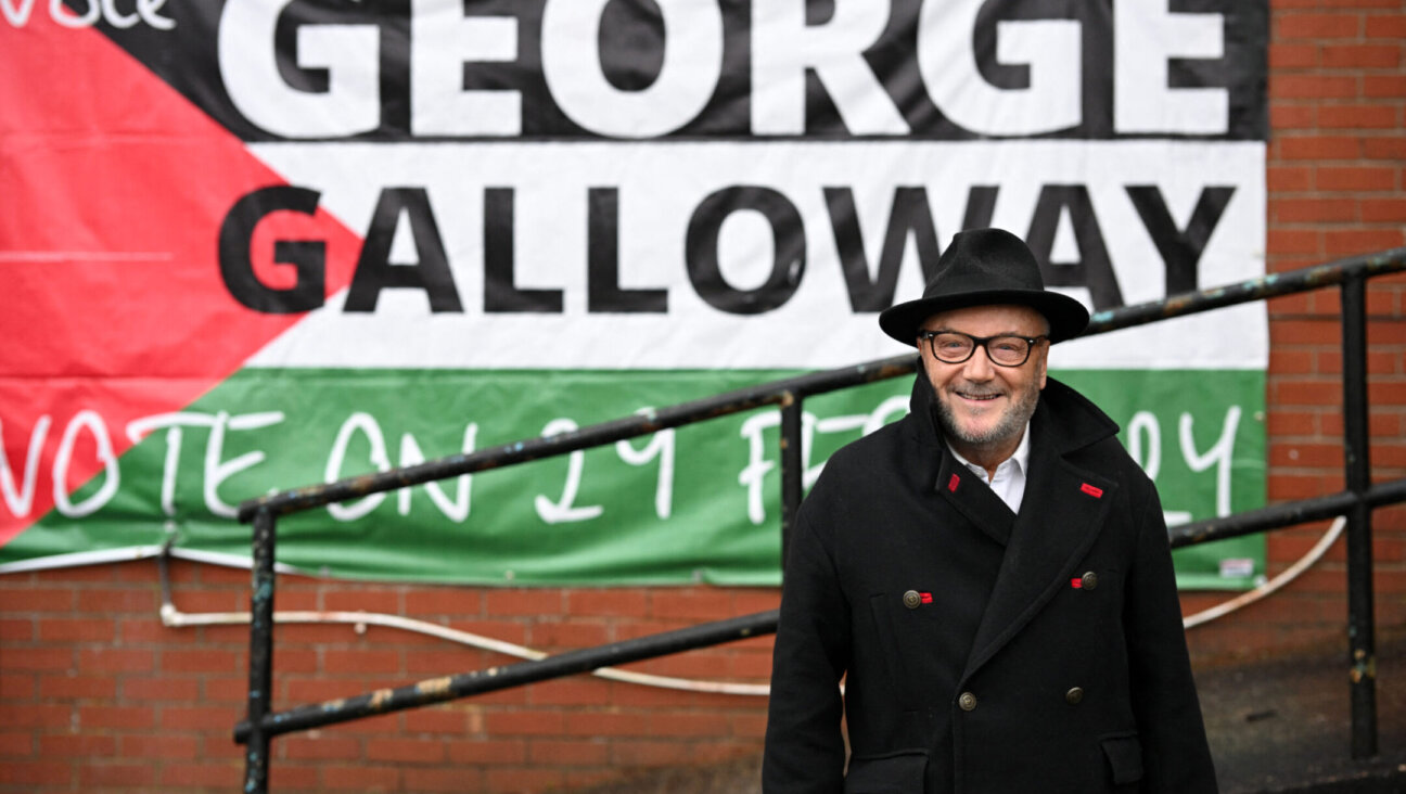 The new Workers Party Member of Parliament for Rochdale, George Galloway, poses for a photograph outside his campaign headquarters in northern England on March 1, 2024, after a campaign that focused on Gaza. (Oli Scarff/AFP via Getty Images)