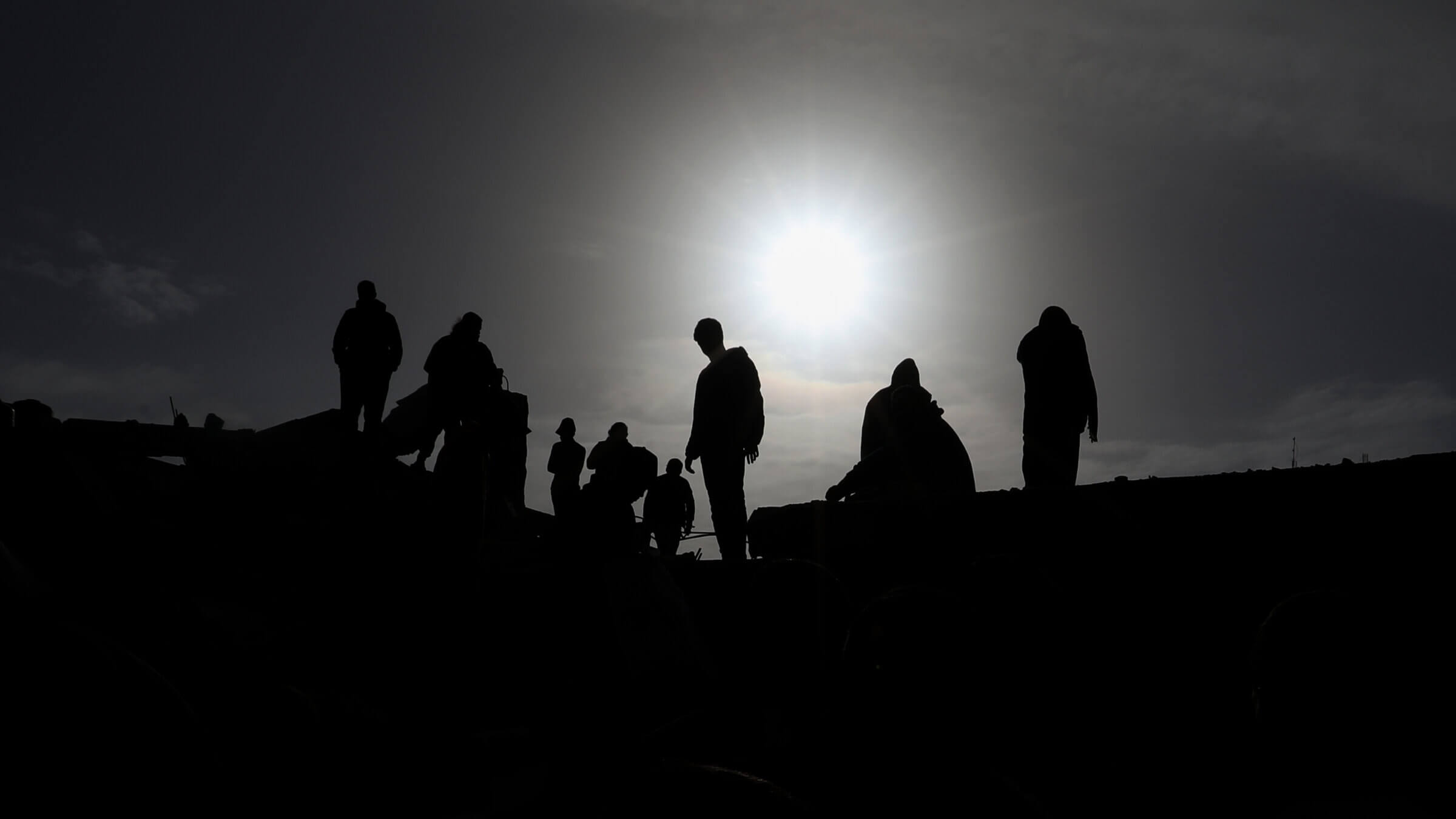 People inspect damage and recover items from their homes following Israeli air strikes, on March 3 in southern Gaza.