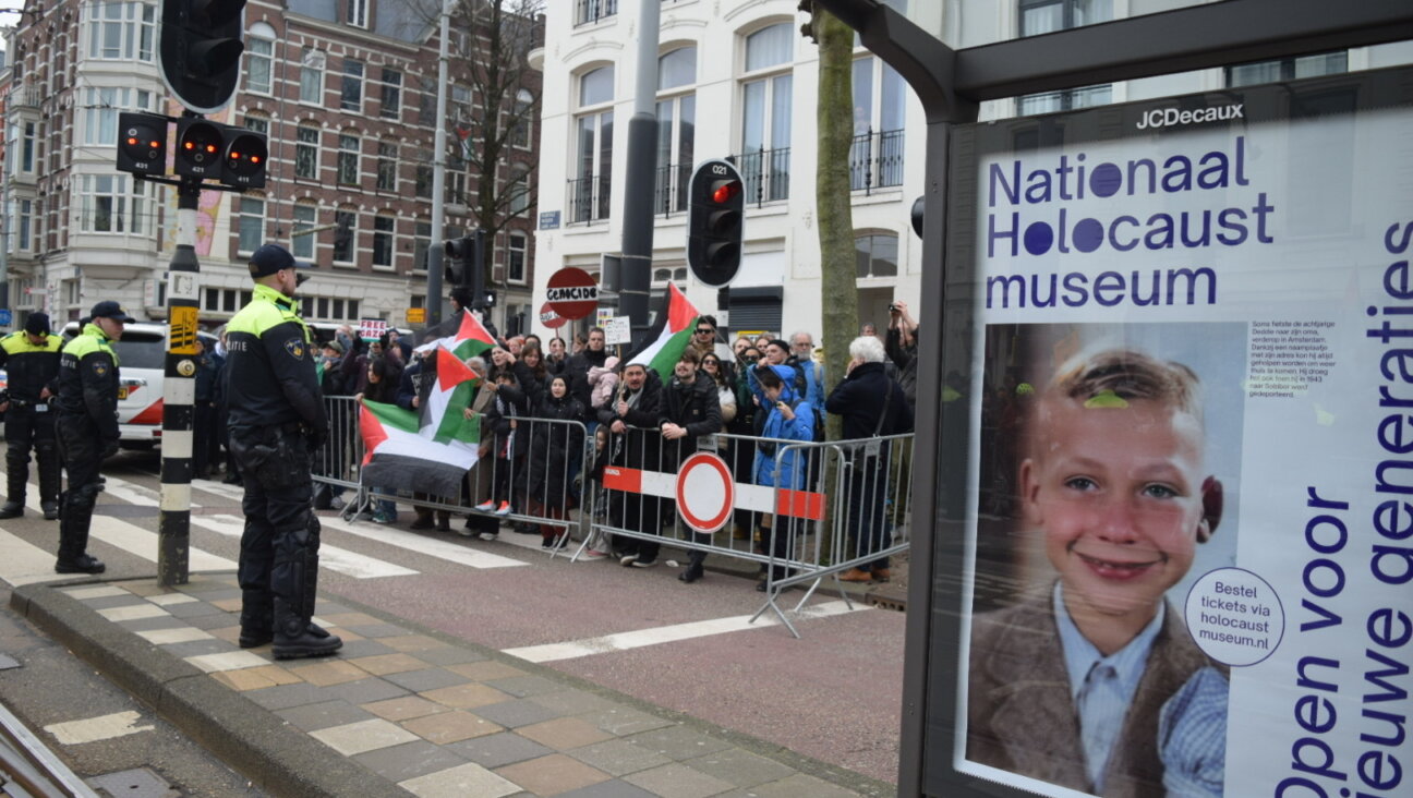 Pro-Palestinian protesters hold flags during a rally outside the opening of the National Holocaust Museum in Amsterdam, Netherlands, on March 10, 2024. (Mouneb Taim/Anadolu via Getty Images)