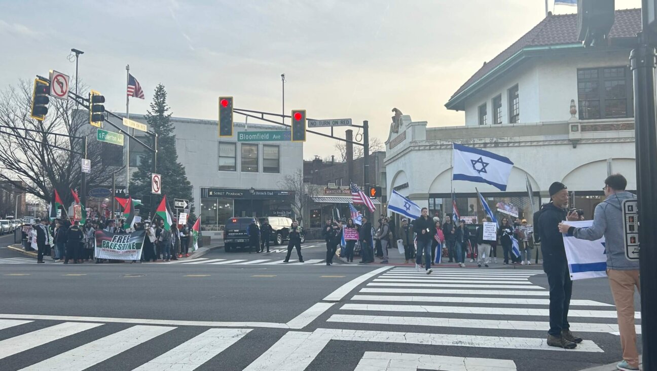 With police forces in between, pro-Palestinian and pro-Israeli protesters stand across the street from one another in Montclair, New Jersey.