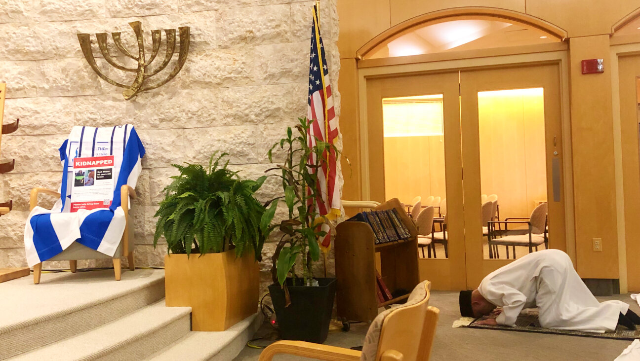 Imam Faizul R. Khan prays at an interfaith service at Congregation B'nai Tzedek in Potomac, Maryland, on March 21, 2024