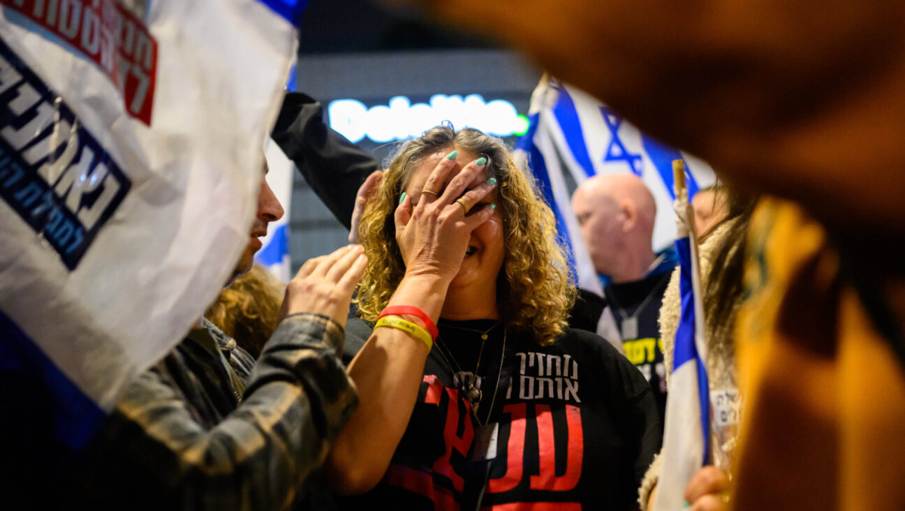 A woman calling for the release of hostages cries after being caught in a clash between demonstrators and police during a recent protest for the release of hostages and against the Israeli government and Prime Minister Benjamin Netanyahu.