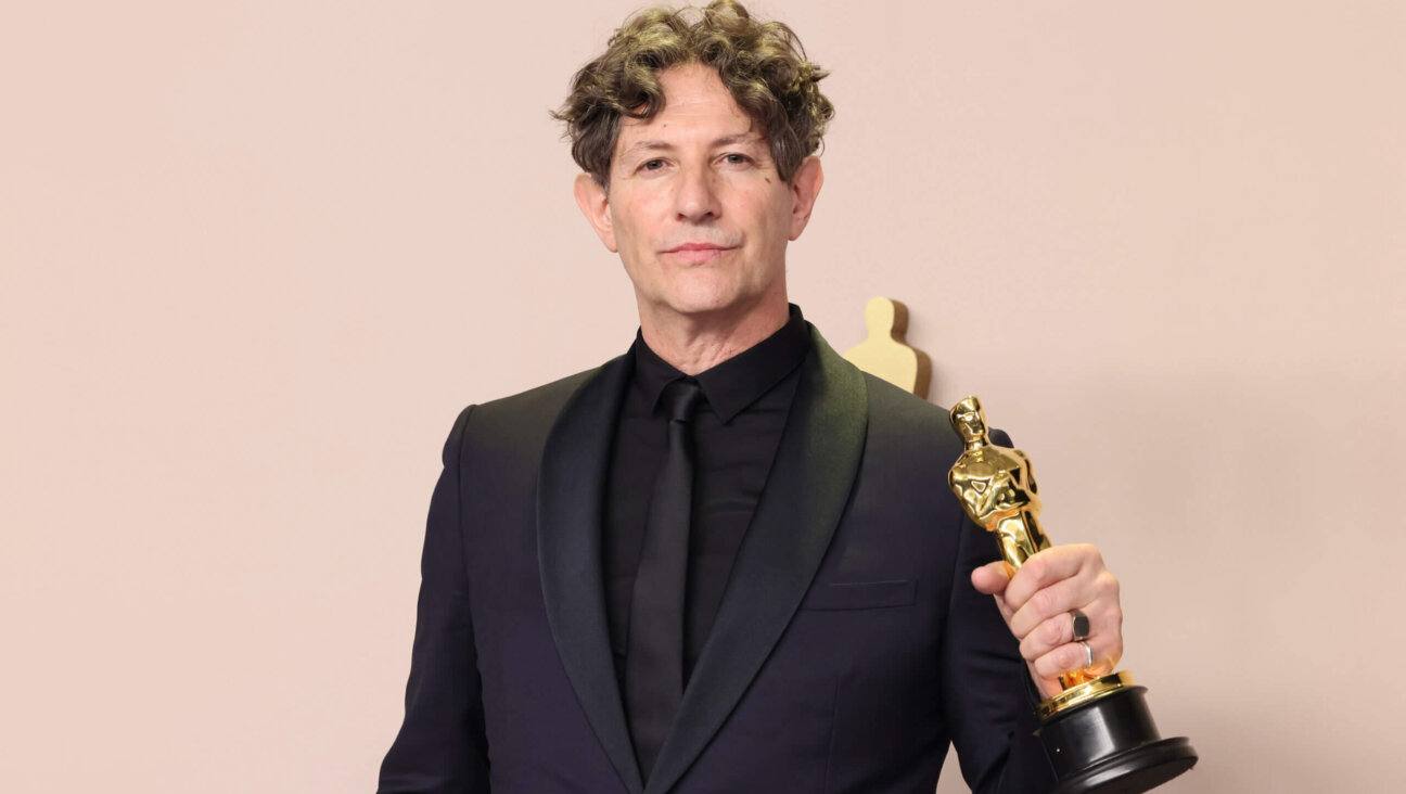 Jonathan Glazer, winner of the best international feature film award for <i>The Zone of Interest</i>, poses in the press room during the 96th Annual Academy Awards. 