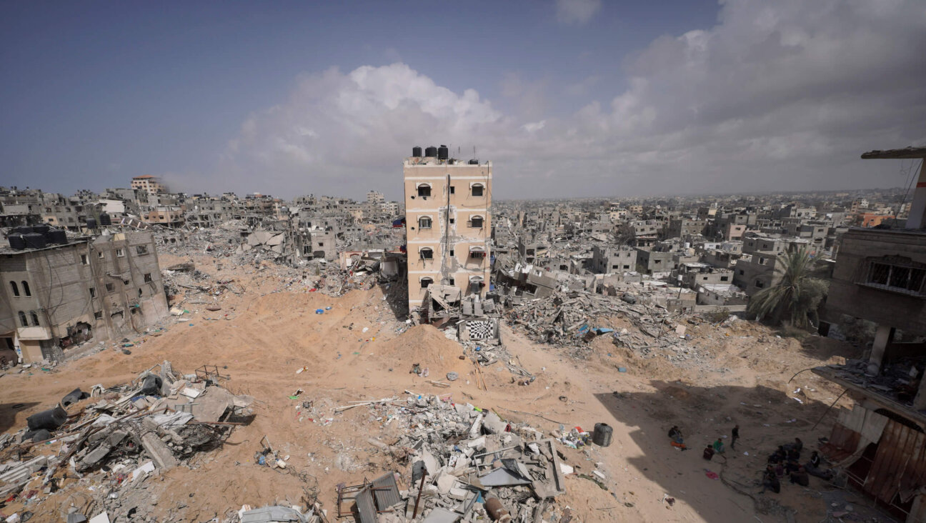 Palestinians stand amid the rubble of houses destroyed by Israeli bombardment in Gaza.