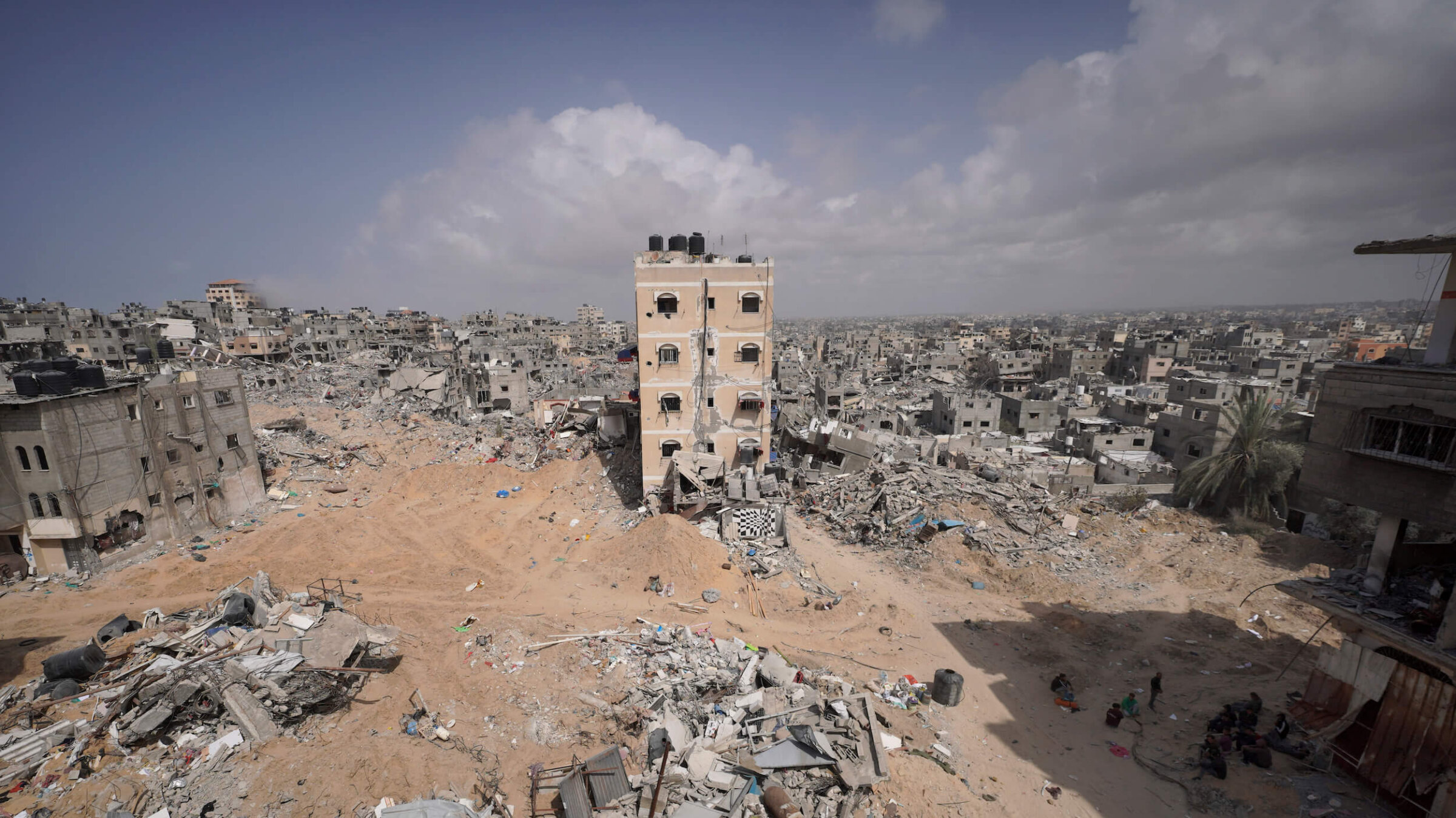 Palestinians stand amid the rubble of houses destroyed by Israeli bombardment in Gaza.