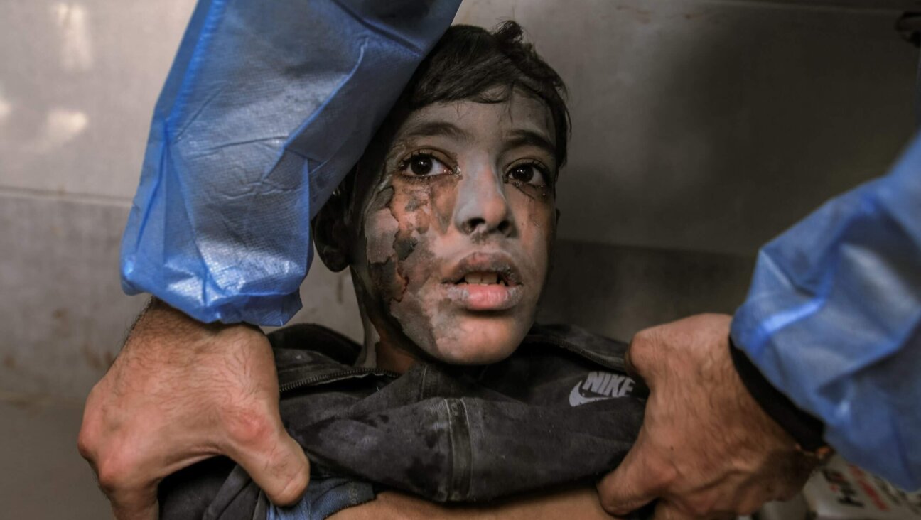 A young boy undergoes a medical examination by a doctor at the overcrowded Al-Shifa Hospital in Gaza City following an Israeli airstrike, Oct. 18, 2023.