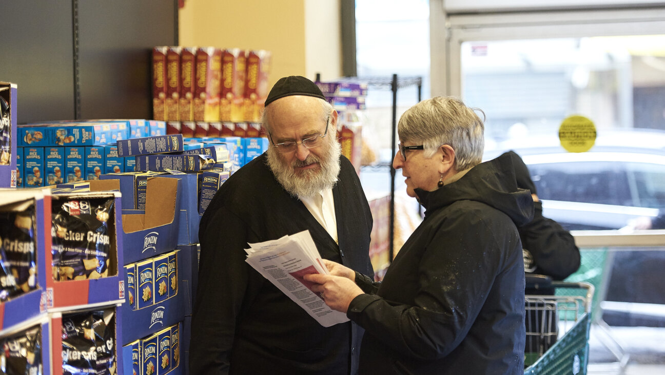 A volunteer with Jews For Racial and Economic Justice speaks about community safety at a New York grocery store in February 2020. The group asked lawmakers this week not to expand the Nonprofit Security Grant Program.