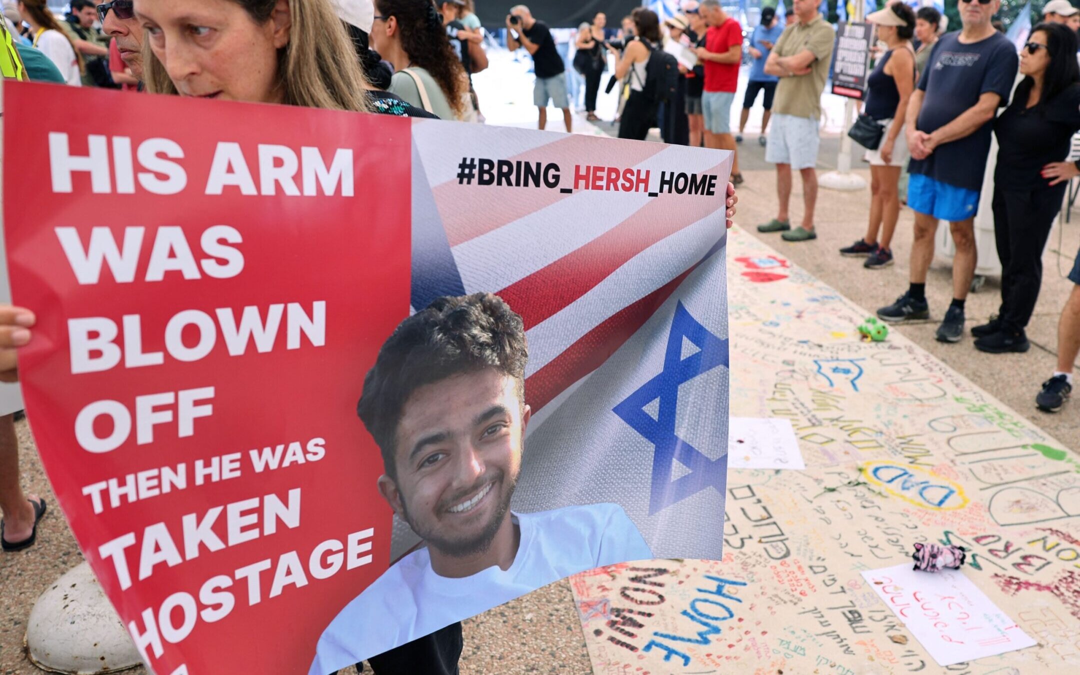 A protester holds a poster with a photo of 23-year-old U.S.-Israeli Hersh Goldberg-Polin as people gather with signs calling for the release of hostages held by Hamas since Oct. 7, during a rally in Tel Aviv Oct. 28.