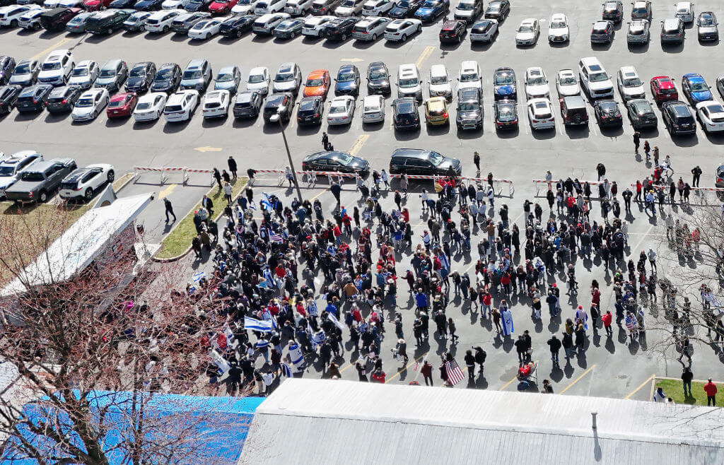 Marchers mass at the Mid Island Y Jewish Community Center following their walk along Old Country Road during the "Bring Them Home NOW" walk and rally on April 07, 2024 in Plainview, New York. The march commemorates six months since the Hamas attack in Israel.