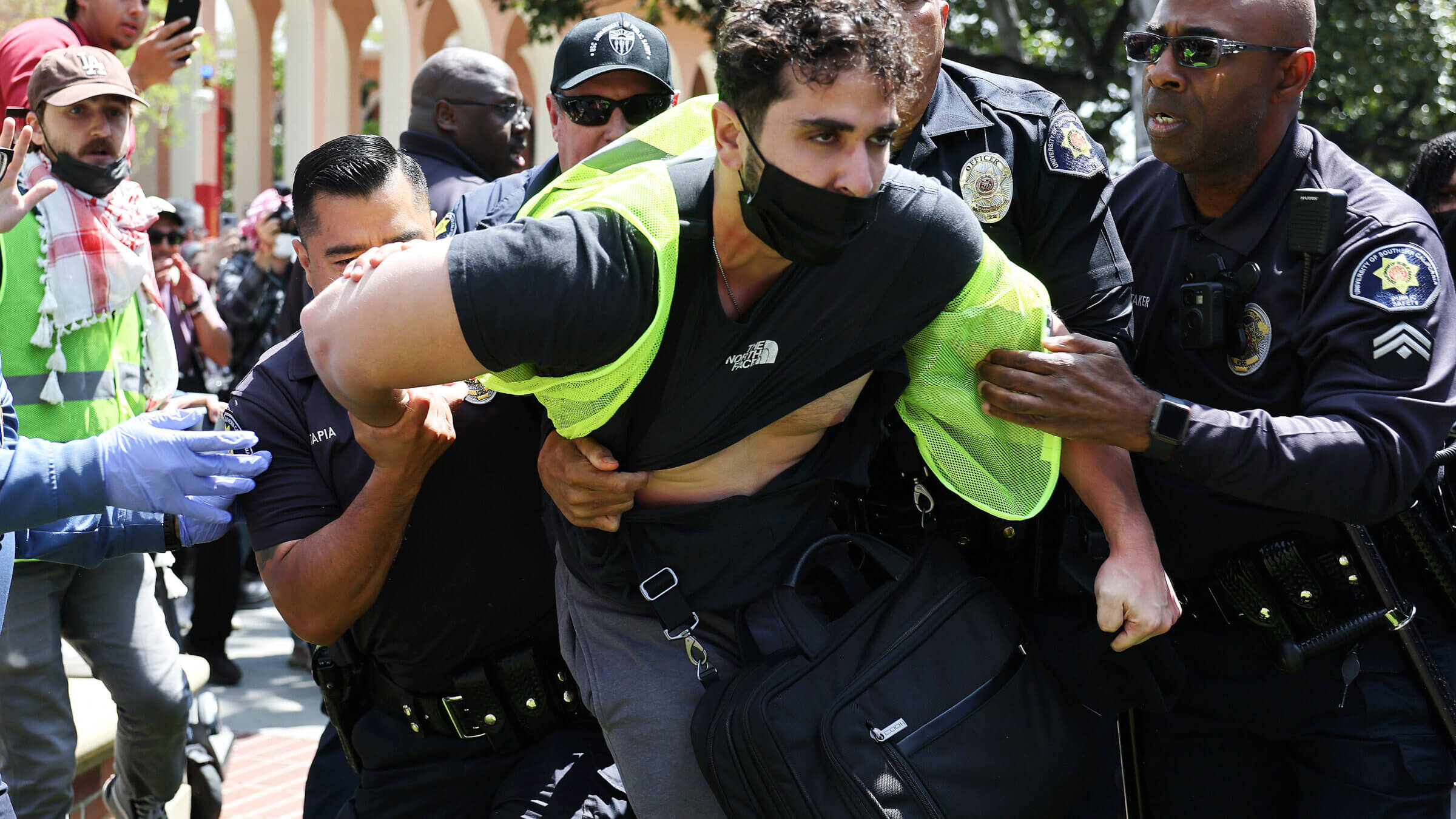 USC public safety officers detain a pro-Palestine demonstrator during clashes after officers attempted to take down an encampment in support of Gaza at the University of Southern California on April 24, 2024  