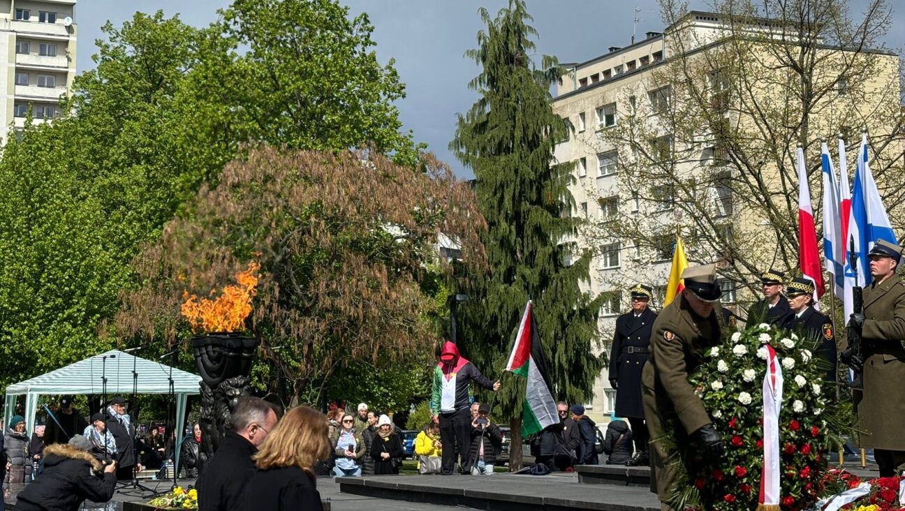 A single pro-Palestinian protester took the stage briefly at the official ceremony to commemorate the 81st anniversary of the Warsaw Ghetto Uprising in Poland, April 19, 2024. (Gabe Miner)