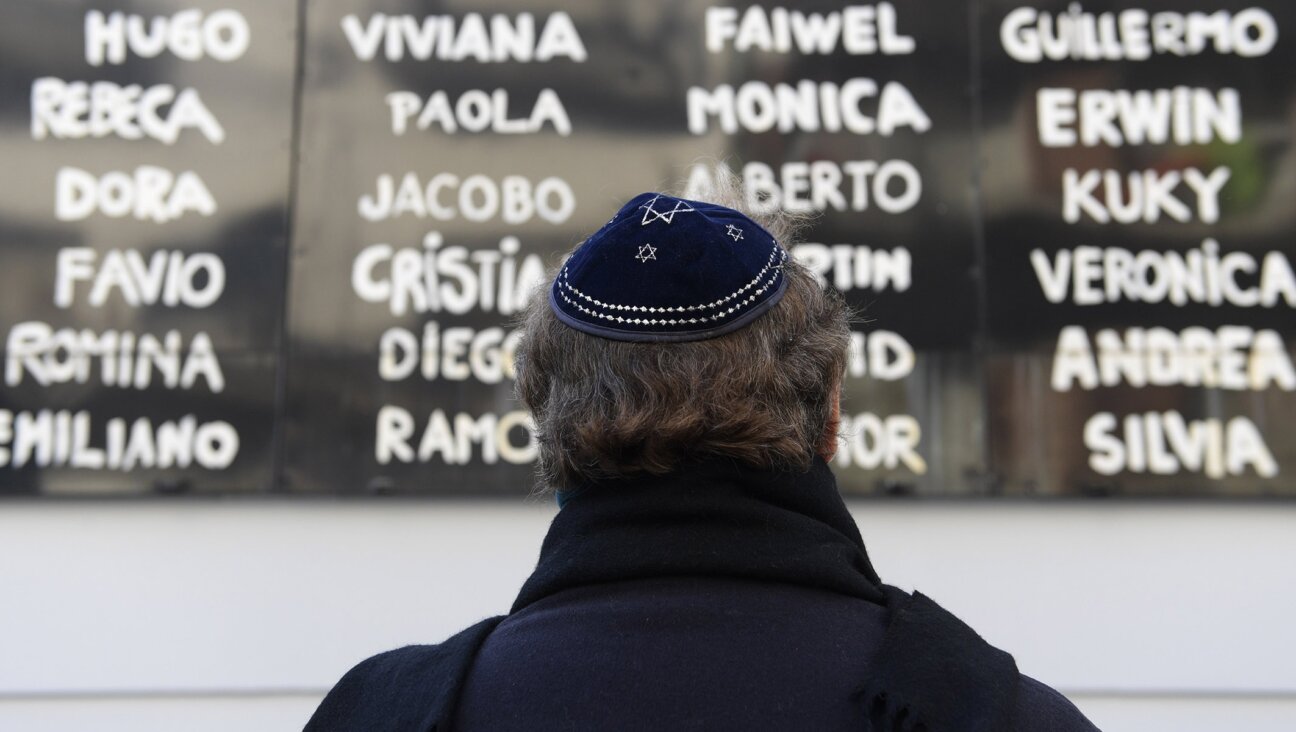 A man prays in front of the AMIA Jewish center during the commemoration of the 23rd anniversary of the terrorist bombing in Buenos Aires, July 18, 2017. (AFP/Juan Mabromata / Getty Images)