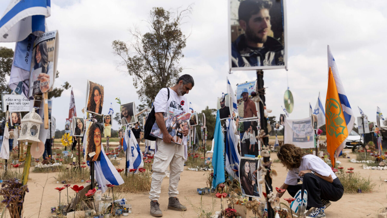 Sigal Manzuri and Amit Cohen visit the marker of their daughters Norelle and Roya who were killed on the Oct. 7 Hamas deadly attack at the Nova music festival on April 7, 2024 in Re'eim, Israel. 