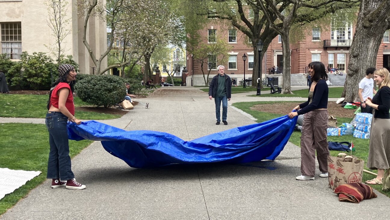 Students from Brown University's encampment fold a tarp as they break their protest down, after reaching an agreement with the university administration.