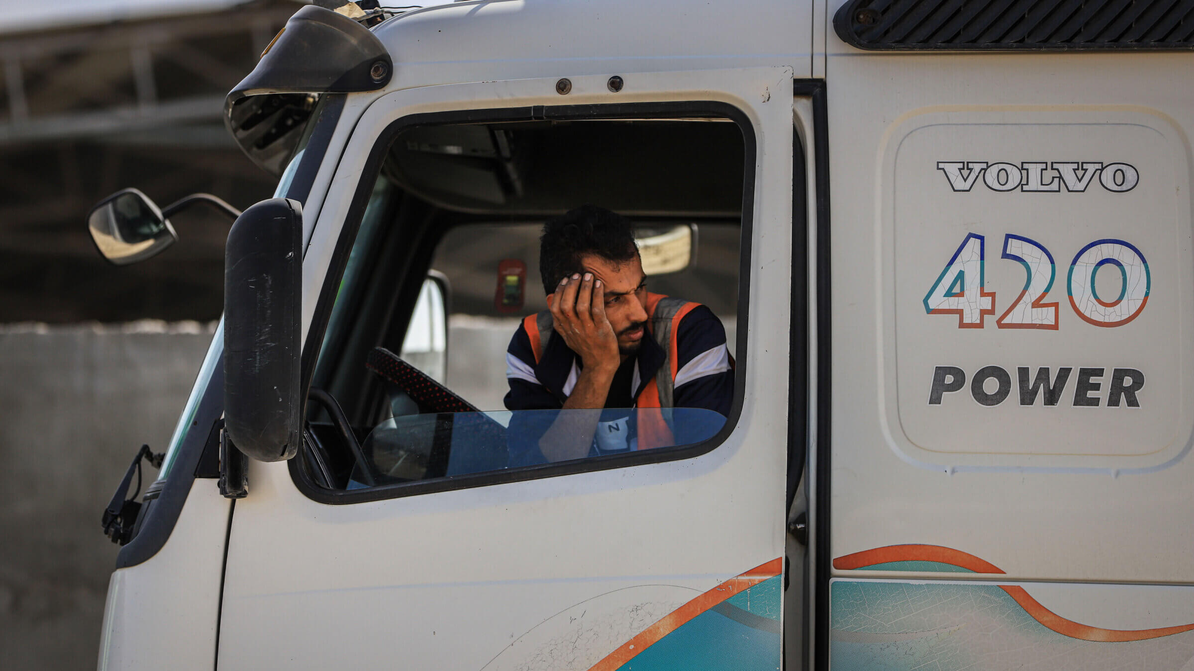 A driver aboard a truck carrying humanitarian aid after crossing from Egypt to the Gaza Strip in October. HIAS, a Jewish organization serving refugees, has faced internal divisions over how to respond to the Israel-Hamas war.