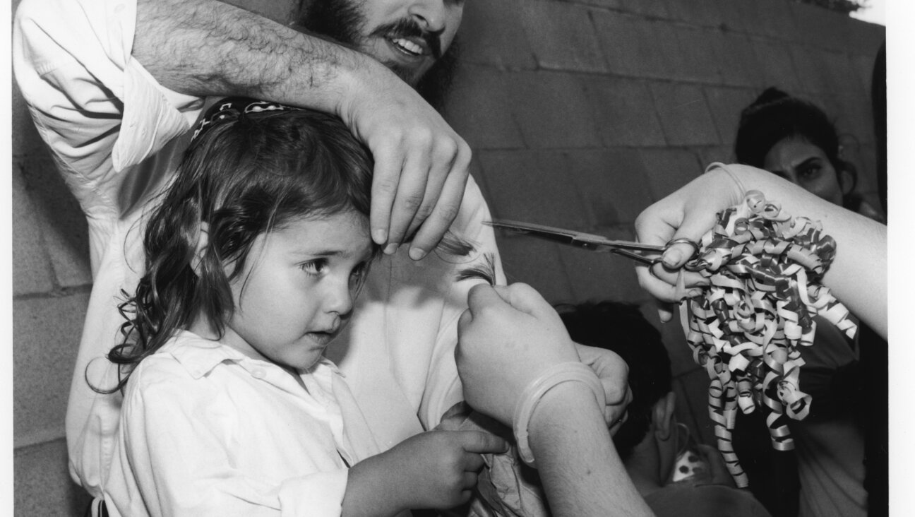 A rabbi performs the upsherin in California.