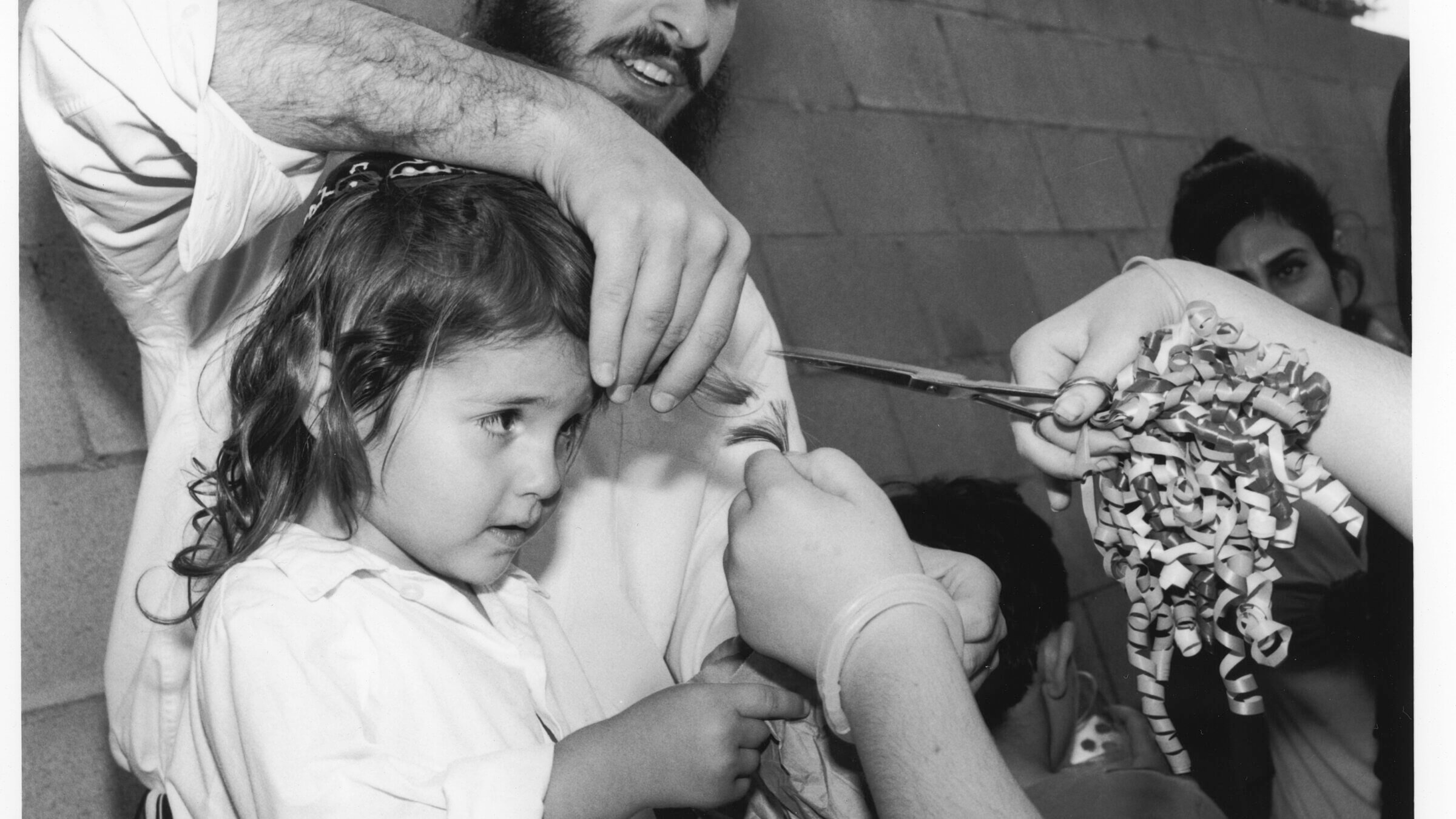 A rabbi performs the upsherin in California.