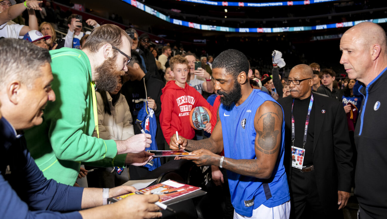 Kyrie Irving signs autographs for fans following a game this spring. The basketball star’s promotion of a documentary that described the Holocaust as a lie seems to have faded from memory.