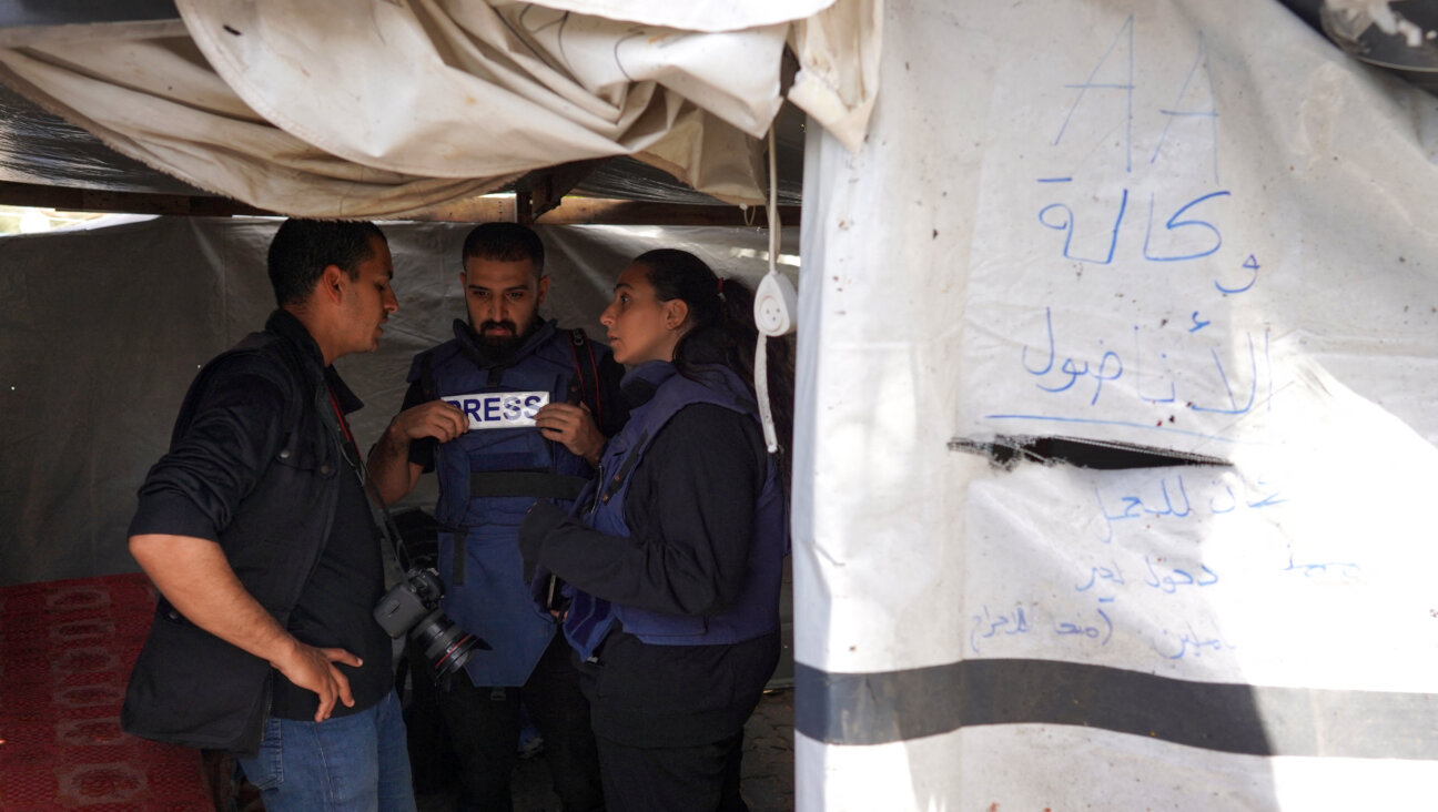 Palestinian journalist Hind Khoudary, right, and Anadolu Agency photographer Ali Jadallah speak with a colleague inside a tent at a makeshift camp for displaced people in front of the Al-Aqsa Martyrs Hospital in Deir al-Balah in the central Gaza Strip, after it was hit by Israel bombardment on March 31.