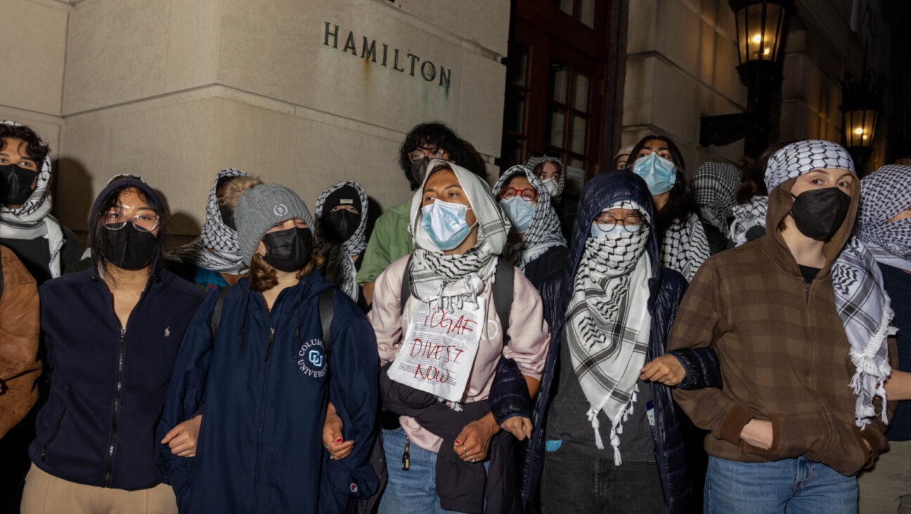 Students/demonstrators lock arms to guard potential authorities against reaching fellow pro-Palestinian protesters who barricaded themselves inside Hamilton Hall, an academic building which has been occupied in past student movements, April 29, 2024. (Alex Kent/Getty Images)