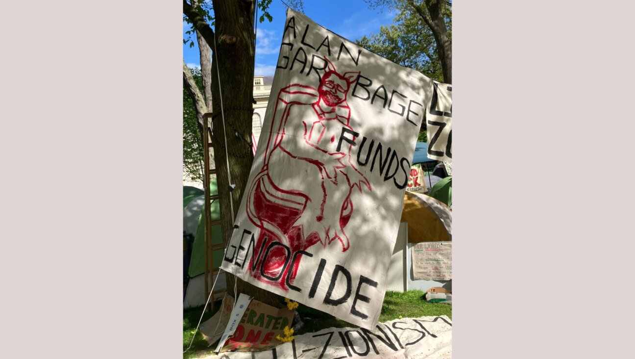 Critics say this sign at a pro-Palestinian encampment at Harvard was antisemitic because it depicts Harvard's Jewish president as a devil. 