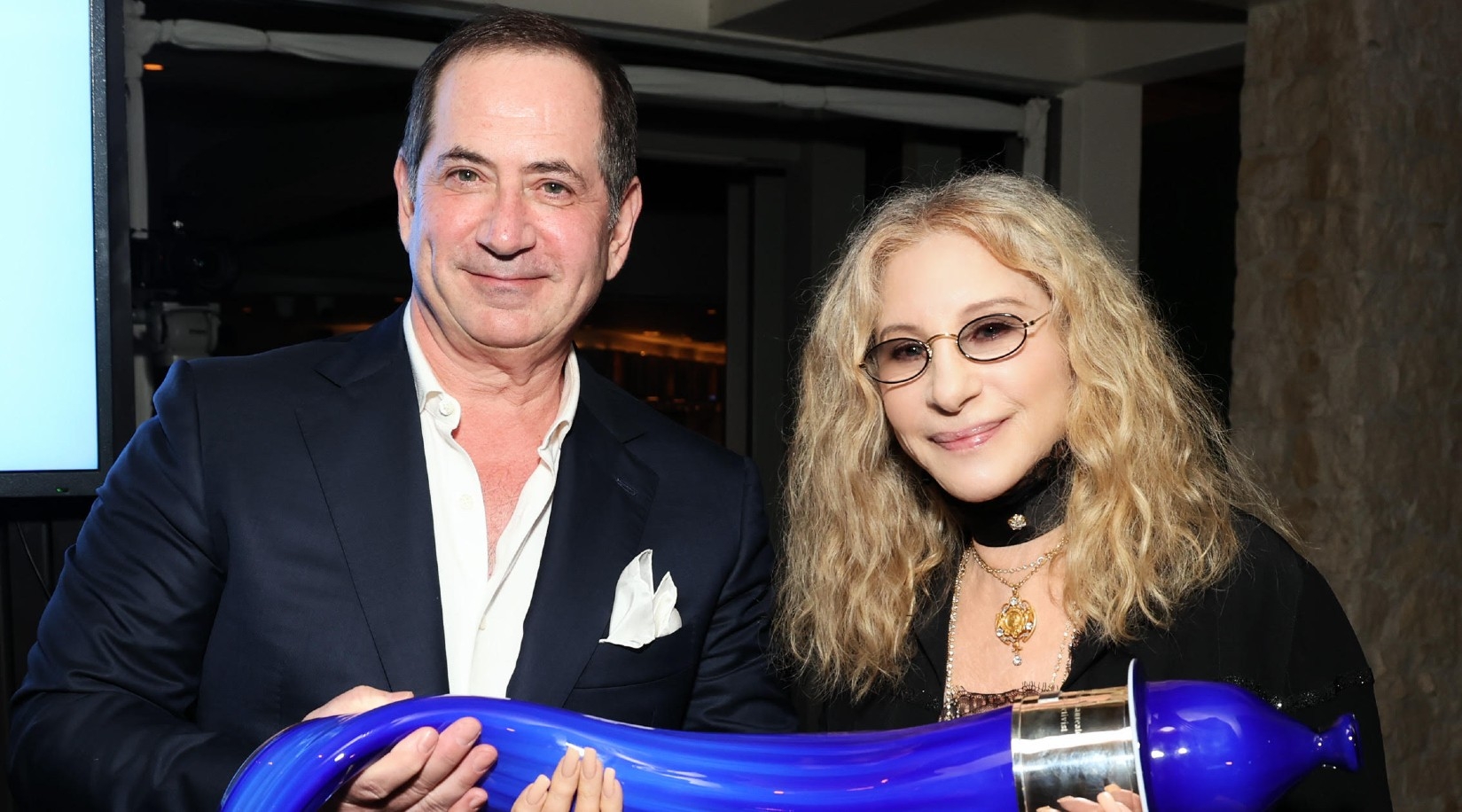 Barbra Streisand, winner of the Genesis Prize, receives a glass sculpture of a shofar from Genesis Prize Foundation co-founder Stan Polovets at a ceremony in Los Angeles, June 6, 2024. (Kevin Mazur/Getty Images for Genesis Prize Foundation)