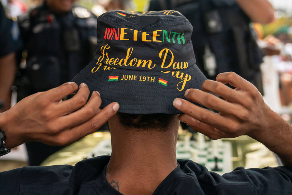 An attendee adjusts his hat during a neighborhood Juneteenth festival on June 17, 2023 in Washington, DC. 