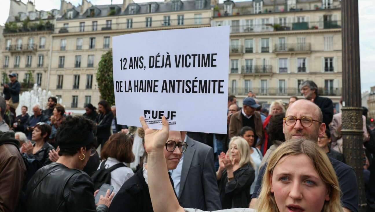 A protester holds a placard which reads as “Twelve-year-old and already a victim of antisemitic hate” as she gathers to condemn the alleged antisemitic gang rape of a 12-year-old girl, at the Paris City Hall square, June 19, 2024. Alain Jocard/AFP via Getty Images)