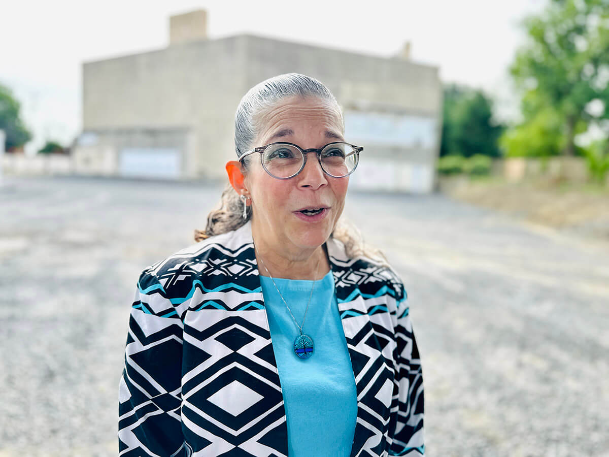 Audrey Glickman, who survived the 2018 attack at Pittsburgh’s Tree of Life synagogue, in front of a hull of the building at a groundbreaking ceremony for a new complex to be built on the site.