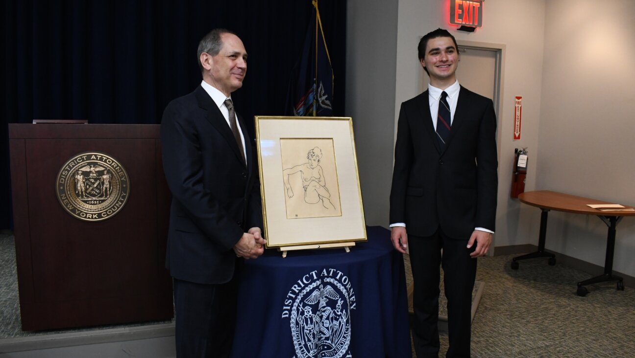 Timothy Reif and son Paul Reif pose in front of “Seated Nude Woman, front view,” an Egon Schiele drawing stolen by the Nazis from the private collection of their ancestor, Fritz Grünbaum. (Jackie Hajdenberg)