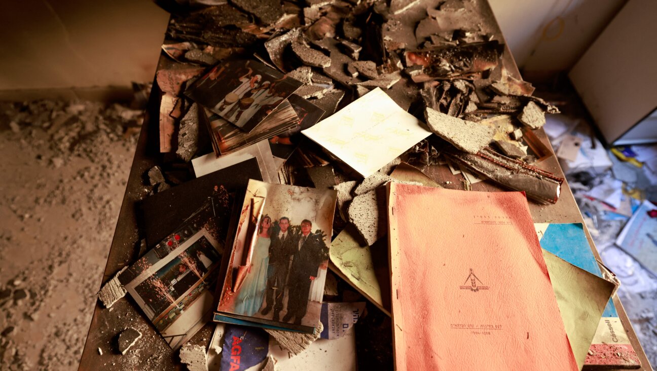 A picture taken during a media tour organized by the Israeli military shows photographs and personal objects inside a house in Kibbutz Nir Oz along the border with the Gaza Strip.