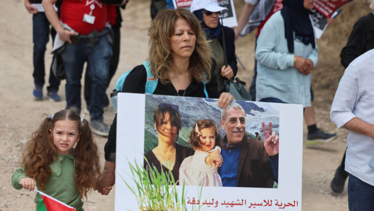 Sanaa Salameh, the wife of Walid Daqqa, and their daughter, Milad, attend a rally commemorating the anniversary of the Nakba following Walid's death. 