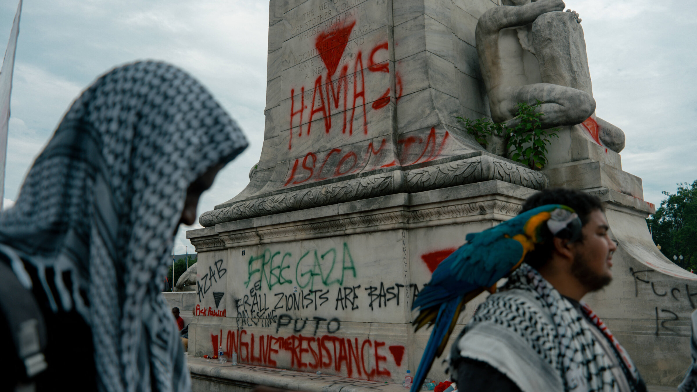 Pro-Palestinian protesters spray paint a message outside the Capitol.