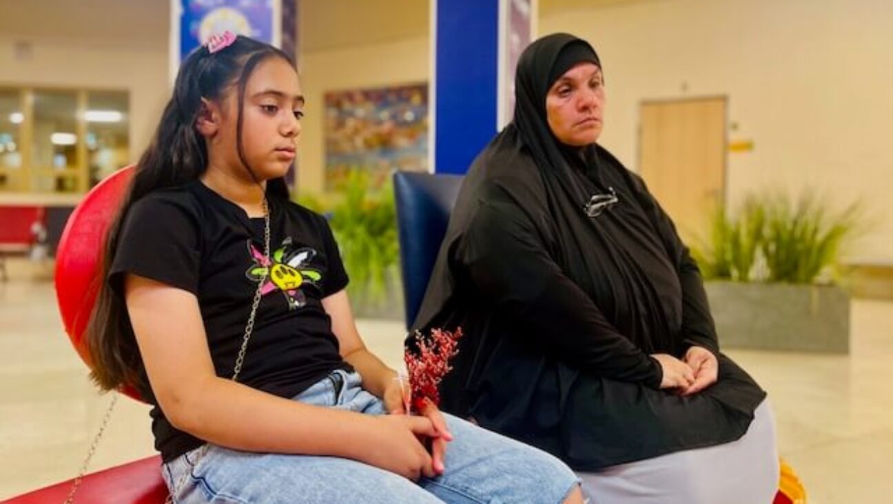 Iptisam Hasanein, right, and her granddaughter, Lujain, both from North Gaza, have spent 15 months sheltered in Israel's Sheba Medical Center as Lujain's 3-year-old brother receives medical treatment. The kids' father was killed in an Israeli airstrike.