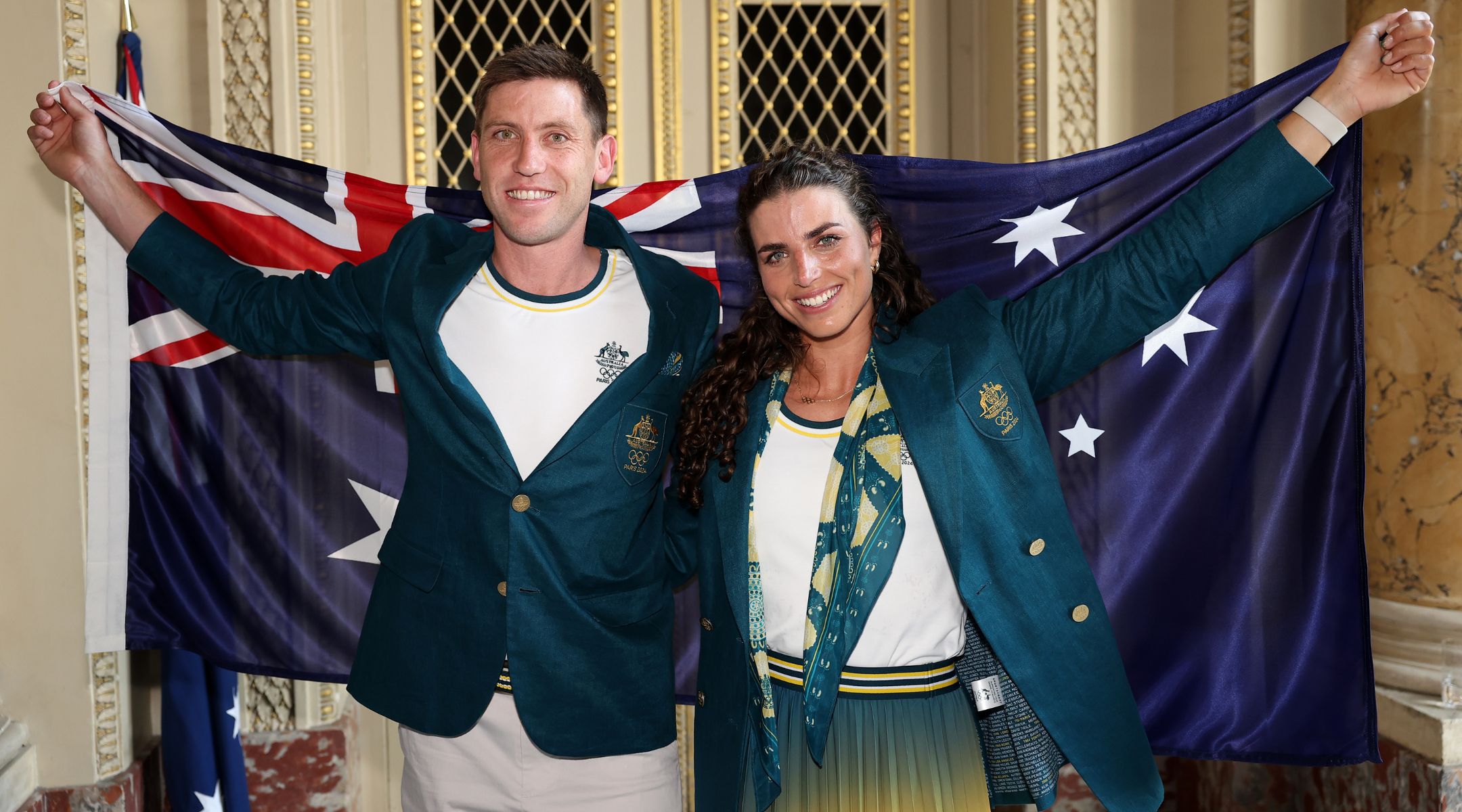 Eddie Ockenden and Jessica Fox pose with the Australian flag after being named flag bearers ahead of the Paris 2024 Olympic Games, July 24, 2024, in Paris. (Richard Pelham/Getty Images)