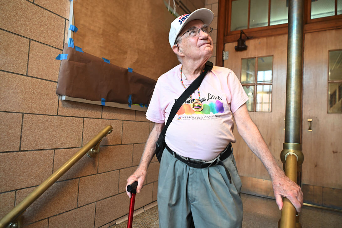 Lew Goldstein in the entryway of P.S. 108, a public school in the Bronx where he was a teacher in the 1970s and 1980s.