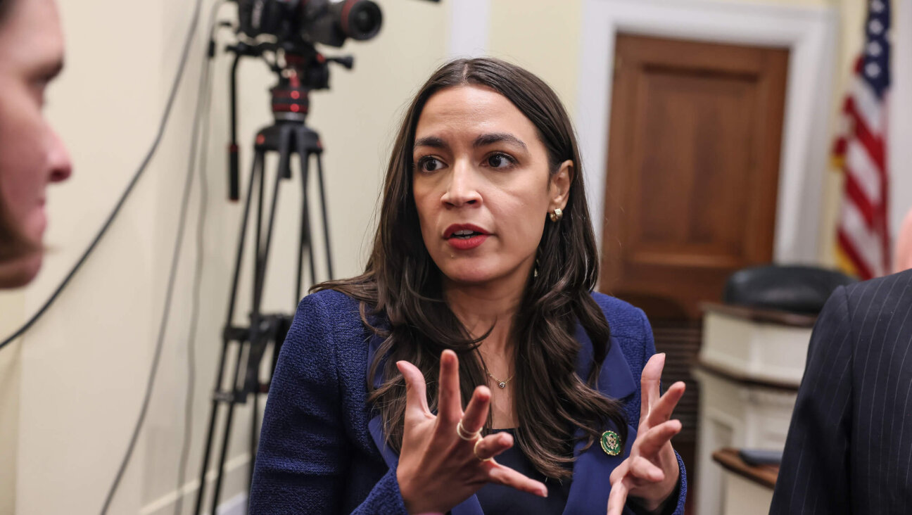 Rep. Alexandria Ocasio-Cortez speaks to journalists on Capitol Hill in June.