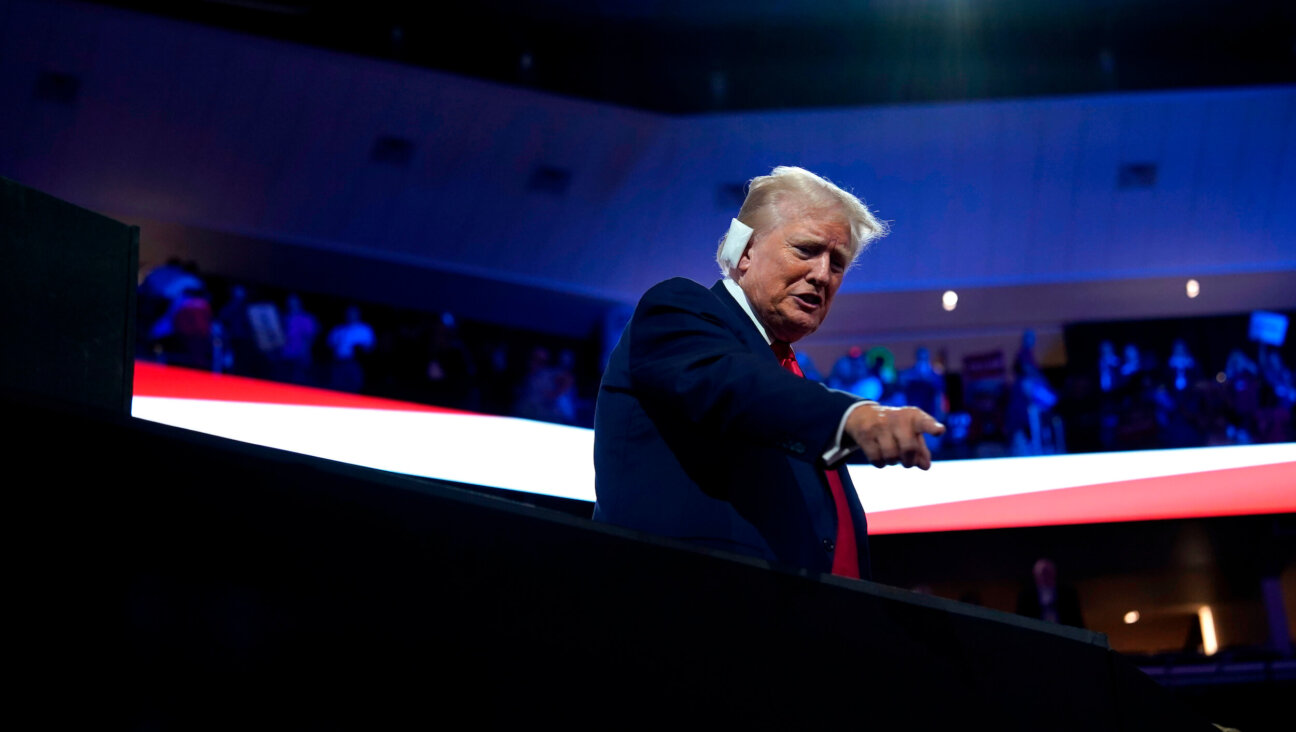 Former President Donald Trump, his ear bandaged after it was hit by a bullet during a Saturday assassination attempt, attends the Republican National Convention in Milwaukee.