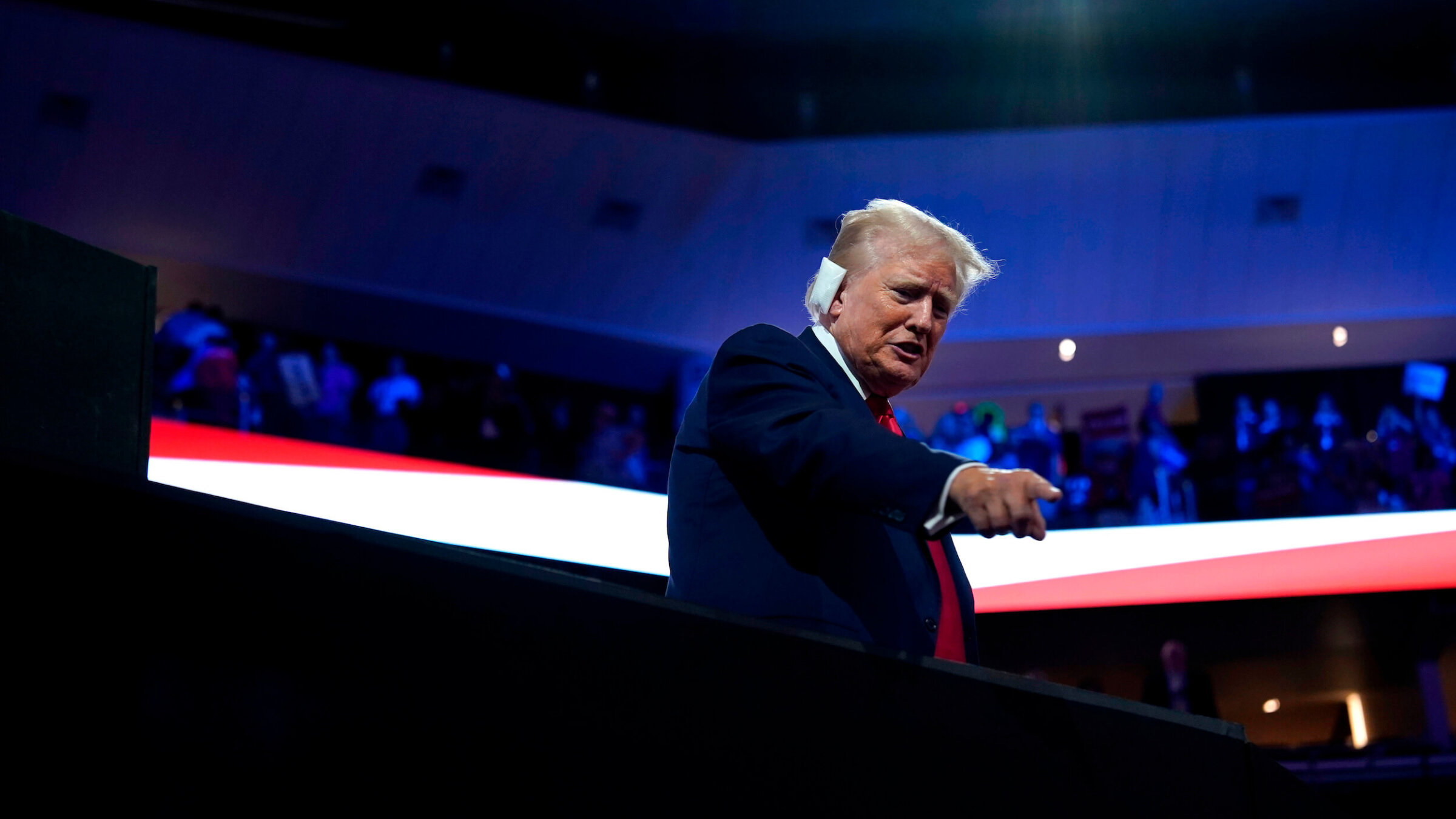 Former President Donald Trump, his ear bandaged after it was hit by a bullet during a Saturday assassination attempt, attends the Republican National Convention in Milwaukee.