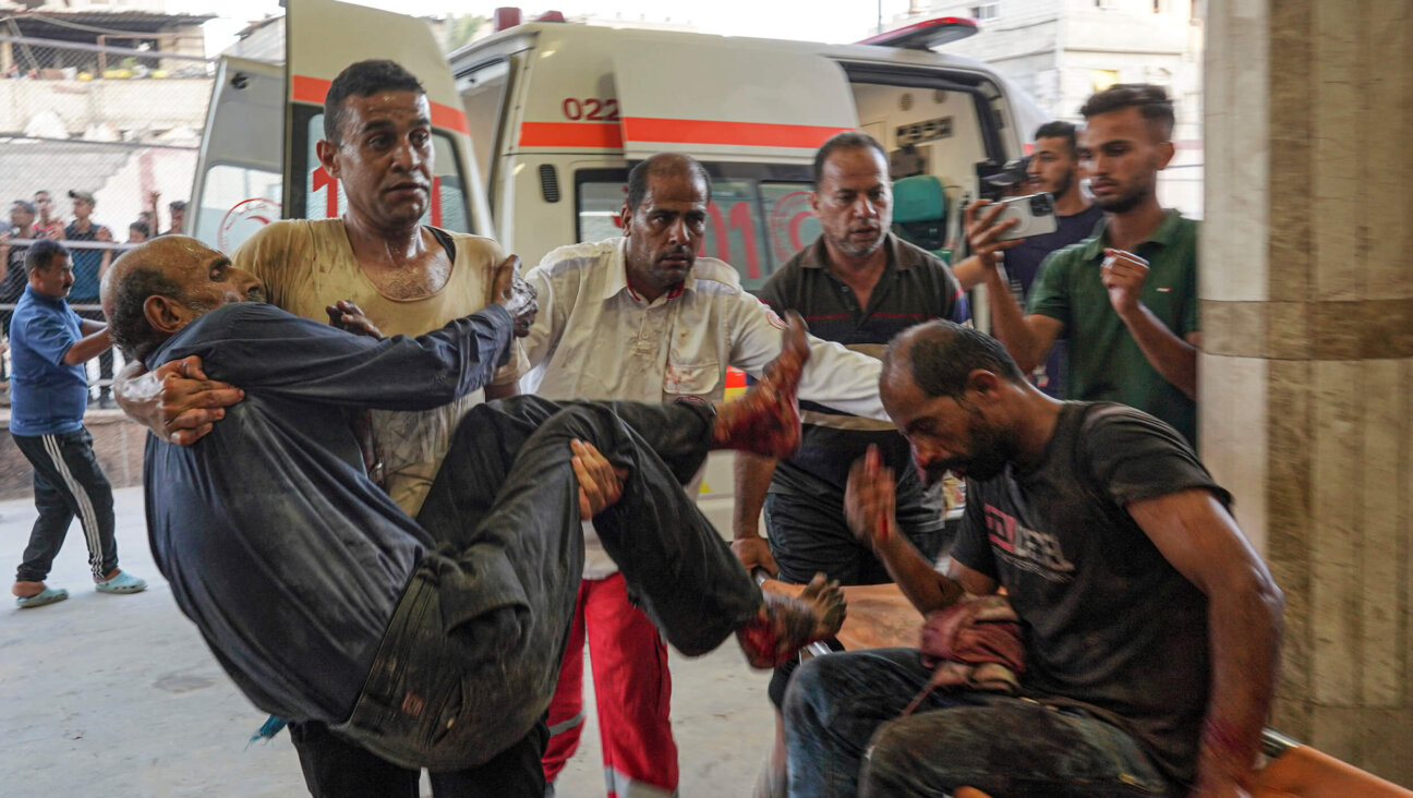 People injured during Israeli bombardment arrive at Nassr hospital in Khan Yunis on July 9. 