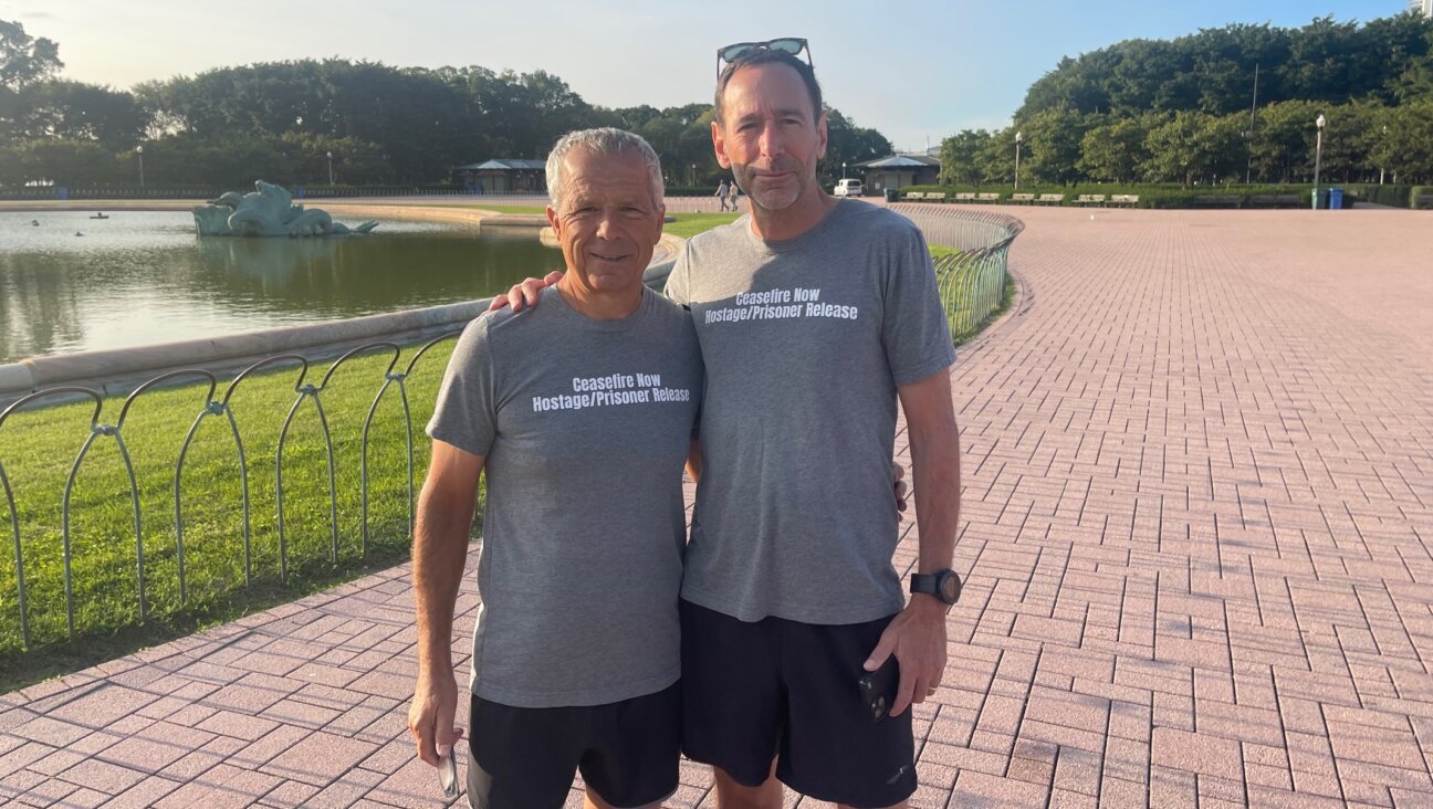 Anan Abu-Taleb. left, and Richard Goldwasser before they start their morning run alongside Lake Michigan, Chicago, Aug. 21, 2024. (Ron Kampeas)