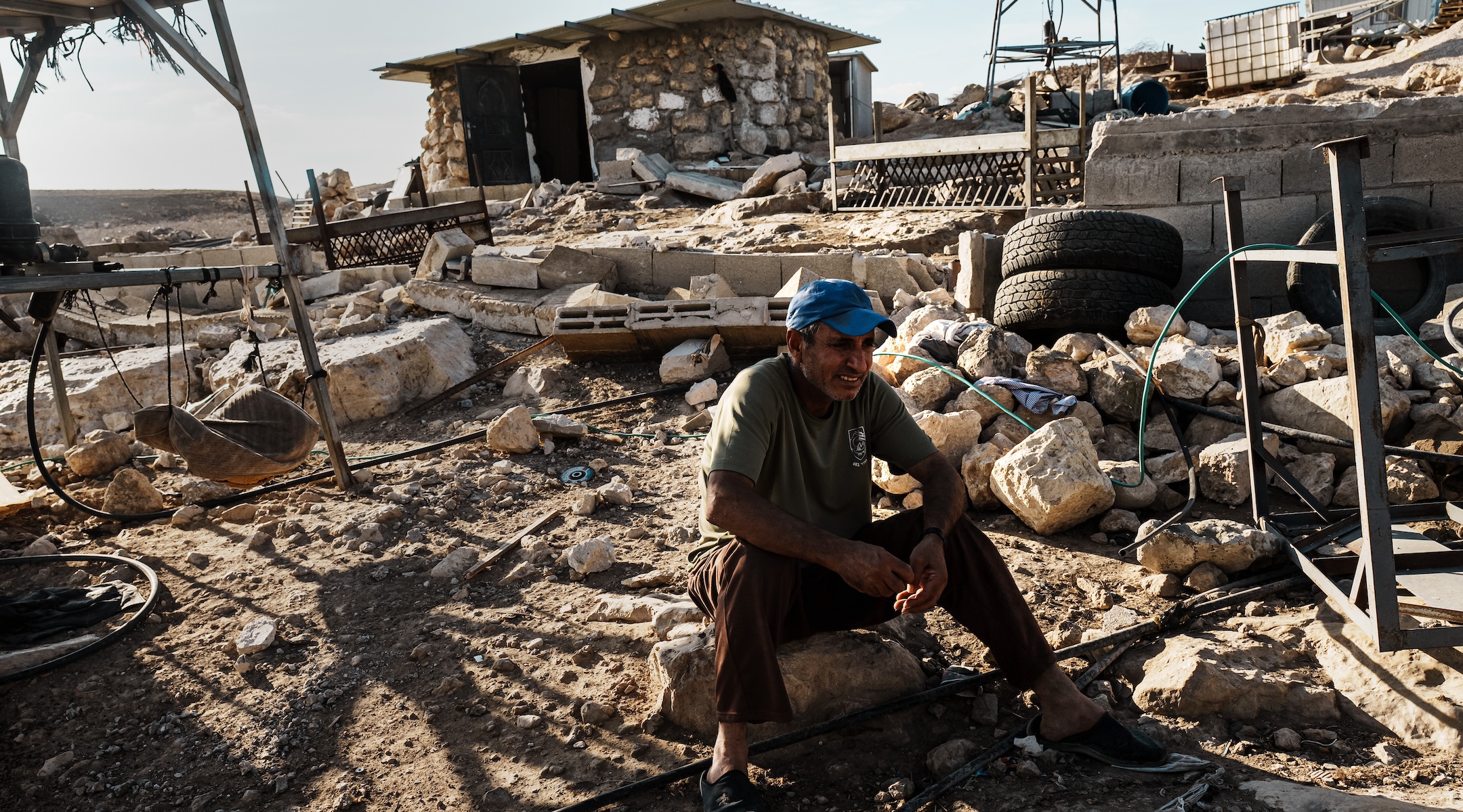 Hamad Melhem al Hudarat reacts as he watches other Palestinian families pack up their belongings, dismantle their homes and uproot their lives along with other Palestinians after a decision was made as a community to leave due to repeated reports of Israeli settler violence and harassment, in the village of Khirbet Zanuta, in the West Bank, Oct. 30, 2023. (Marcus Yam/ Los Angeles Times)