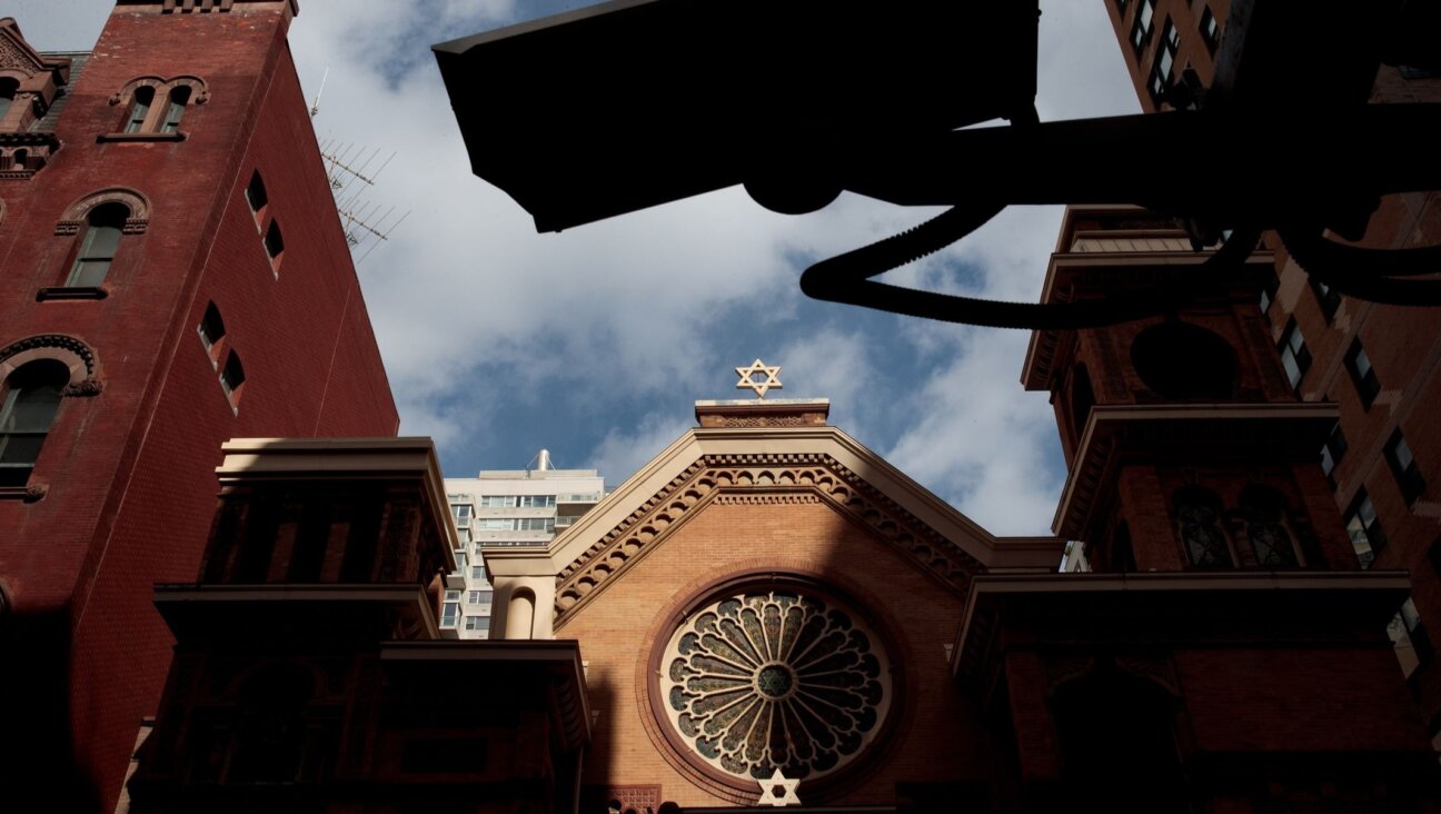 A security camera hangs across the street from the Park East Synagogue, in New York City. Jewish institutions are tightening security amid rising threats. (Drew Angerer/Getty Images)