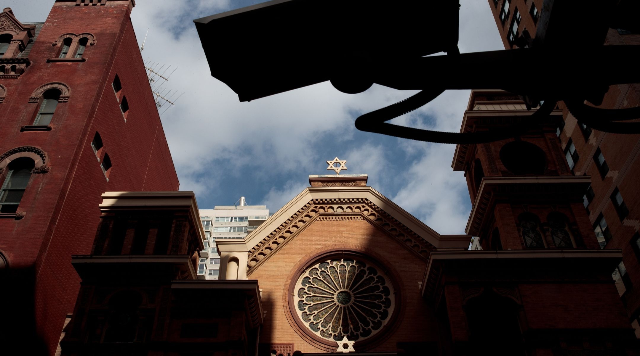 A security camera hangs across the street from the Park East Synagogue, in New York City. Jewish institutions are tightening security amid rising threats. (Drew Angerer/Getty Images)