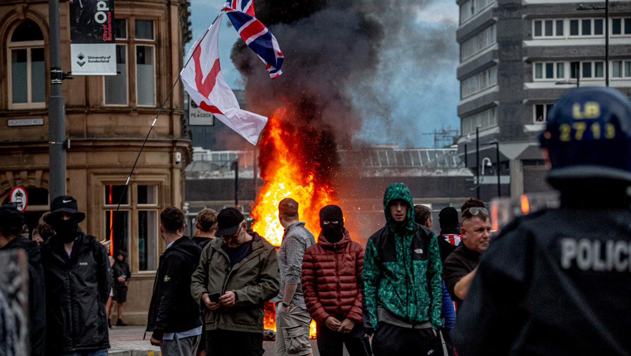 Far-right activists hold an ‘Enough is Enough’ protest in Sunderland, England, August 2, 2024. After the murders of three girls in Southport earlier this week, misinformation spread via social media and fueled acts of violent rioting from far-right, anti-immigration actors across England. (Drik/Getty Images)