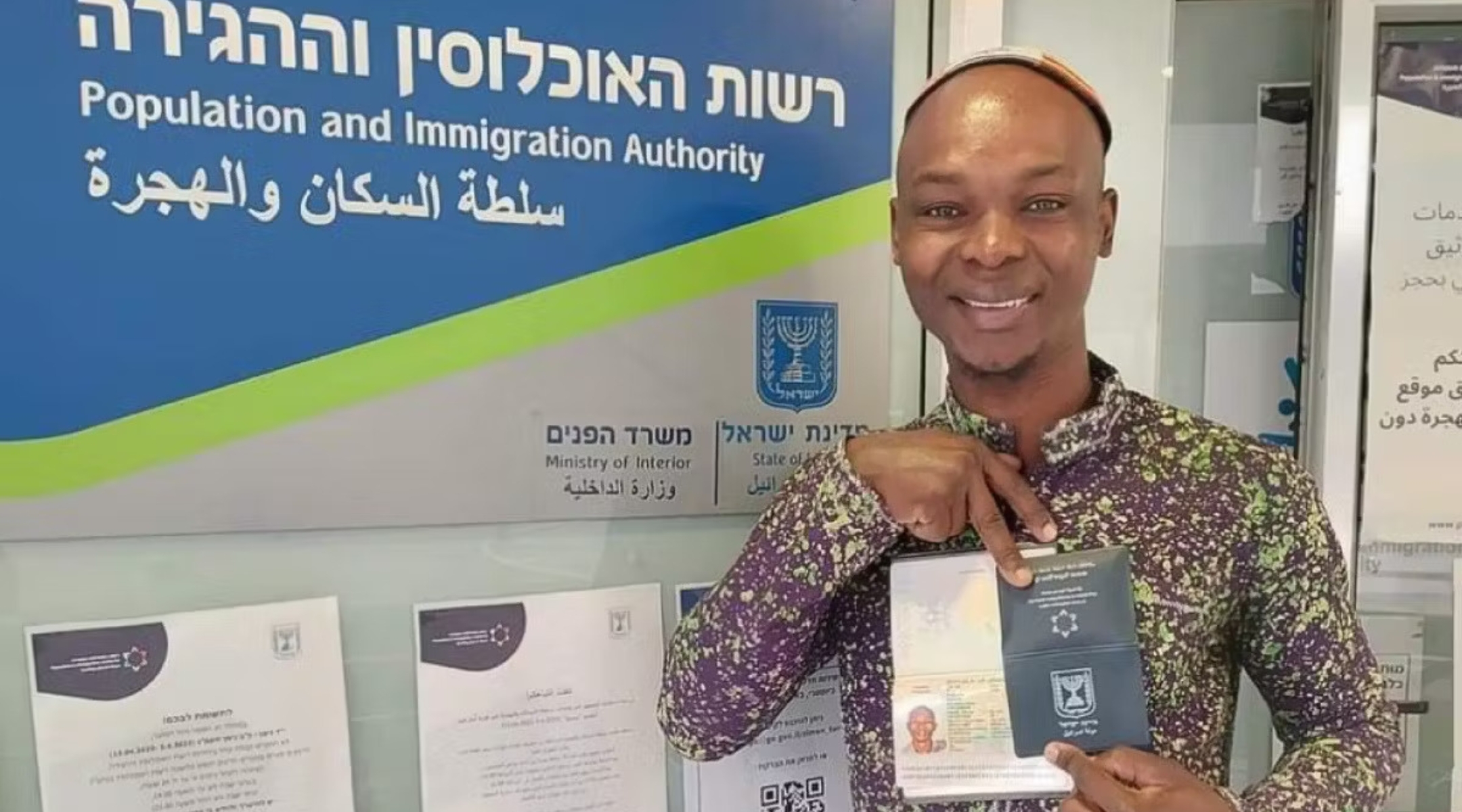 Yosef Kibita poses with his new Israeli passport. (Courtesy Masorti Movement in Israel)